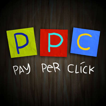 The words PPC Pay Per Click written on sticky colored paper over dark wooden planks