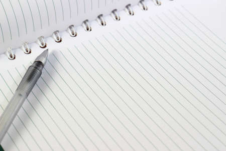 Image of a pen on blank white notebook