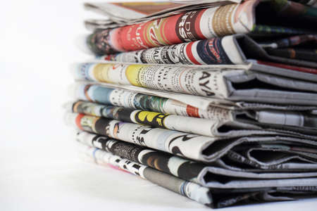Image of stack of newspapers on white backgroundの写真素材
