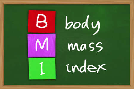 Health concept image of BMI body mass index written on colored paper over green chalkboardの写真素材