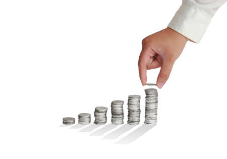 Businessman hand put coins to ladder stack of coins isolated on white