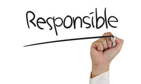 Business concept image of a hand holding marker and write Responsible isolated on whiteの写真素材