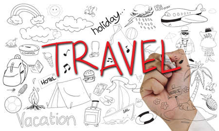 Holiday concept image of a hand holding marker and write Travel doodleの写真素材