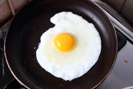Food photography closeup photo of bullseye egg fried in a panの写真素材