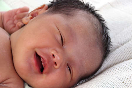 Cute newborn baby girl smile while sleeping
