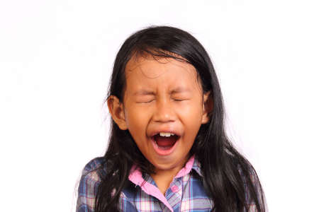 Little girl tired and yawning isolated on white