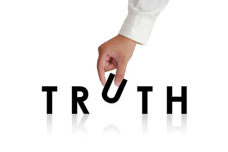 Gesture of hand picking up letters and making Truth word isolated on whiteの写真素材