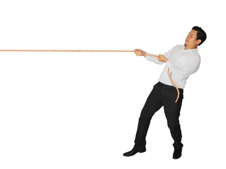 Young Asian male pulling rope isolated on white