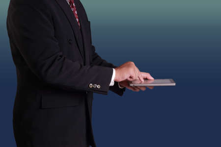 Business concept image of a businessman using digital tablet, side view