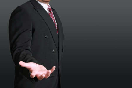 Business concept image of a businessman with open palm in position of holding somethingの写真素材