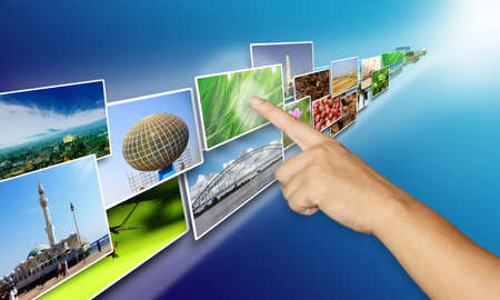Internet media sharing concept, hand pointing and picking image on internet sharing media over blue backgroundの写真素材