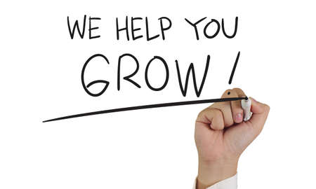 Motivational concept image of a hand holding marker and write We Help You Grow isolated on whiteの写真素材