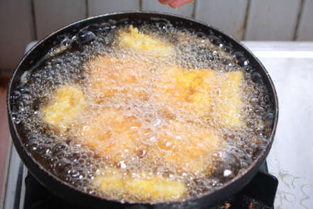 Close up image of cooking chicken nugget tempura in deep fryの写真素材