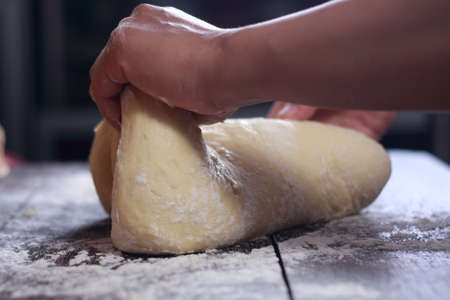 Close up image of bakery chef making bread dough in the kitchenの写真素材