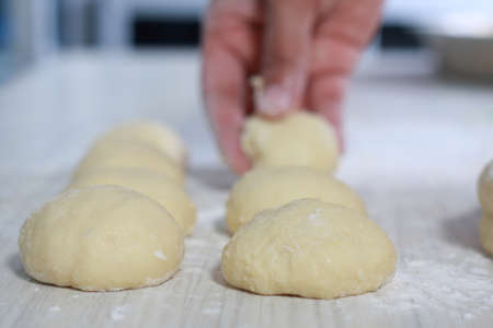 Close up image of bakery chef making bread dough in the kitchenの写真素材