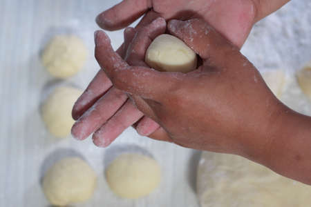 Close up image of bakery chef making bread dough in the kitchenの写真素材