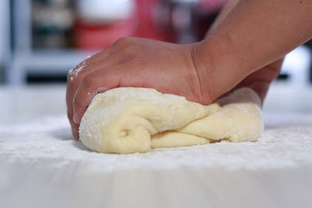 Close up image of bakery chef making bread dough in the kitchenの写真素材