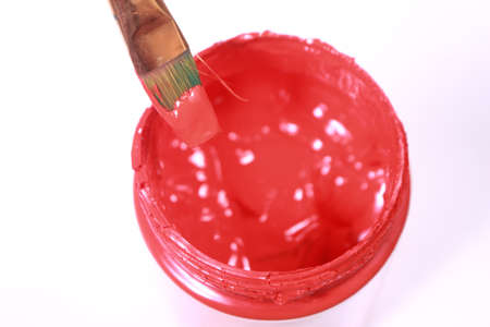 Painting brush with red acrylic paint in bottle from above viewの写真素材