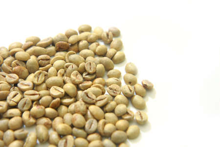 Close up image of raw coffee beans isolated on whiteの写真素材
