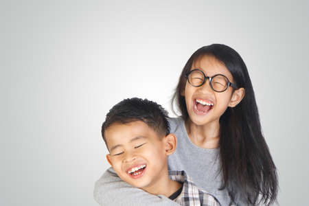Portrait of young happy Asian brother and sisterの写真素材