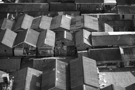 Abstract image of asian slums, dense village, house roof in black and white monochrome photoの写真素材