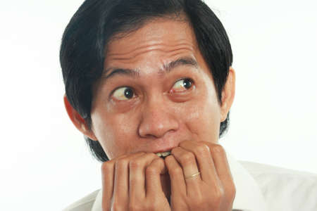 Photo image portrait of a funny young Asian businessman looked very scared and worried, close up...