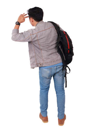 Photo image portrait of a young Asian male student standing and looking forward, rear view, isolated on whiteの写真素材