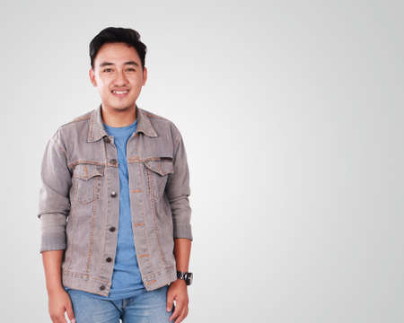 Photo image portrait of a cute young successful Asian male student, in relaxed standing positionの写真素材
