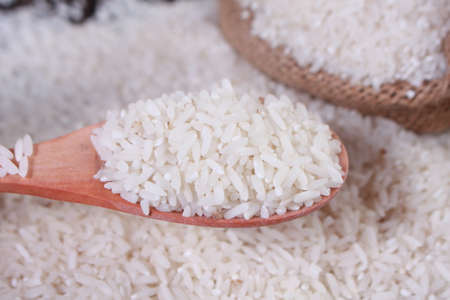 Photo image. Food photography. Raw uncooked white rice cereal grain background. Asian main...