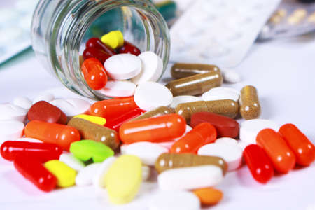 Variety of different tablets pills capsule heap mix therapy drugs pharmacy medical background