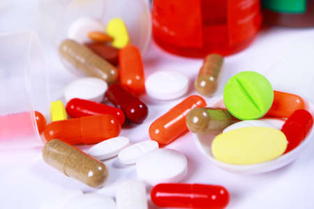 Variety of different tablets pills capsule heap mix therapy drugs pharmacy medical background