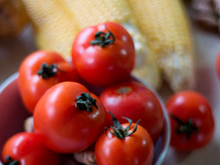 Fresh raw mixed vegetables and herbs. Healthy vegetarian food meal preparation. Corns tomatoes...