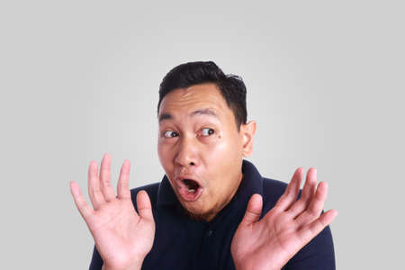 Photo image of young funny Asian man shocked or surprised expression with mouth openの写真素材