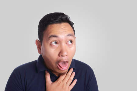 Photo image of funny Asian man chocked or sick nausea puke vomit with tongue out