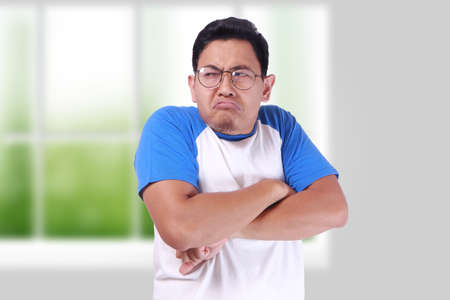 Photo image of funny Asian man showing synical unhappy angry facial expression