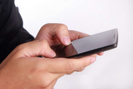 Close up image of hand holding and using smartphone, touching screen