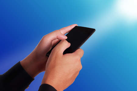 Close up image of hand holding and using smartphone, touching screenの写真素材