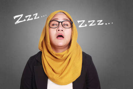 Portrait of muslim businesswoman tired and sleeping at workの写真素材