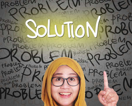 Muslim woman wearing hijab get an idea of solution to conquer problemsの写真素材