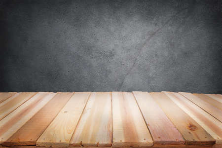 Empty wooden deck table with dark grunge wall background. Product display montage mockup template