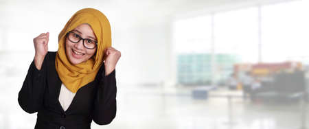 Portrait of success beautiful muslim businesswoman wearing hijab and eyeglasses winning victory...