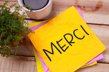Merci, French thank you words letter, written on piece of memo paper. Motivational business typography quotes conceptの写真素材