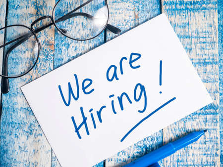We Are Hiring, Motivational Business Recruitment Words Quotes Concept words letter, written on paper, work desk top view typography.の写真素材