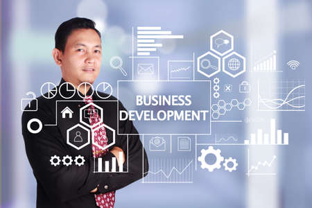 Business concept. Asian businessman smiling with Business development words written on virtual screen. Text typography designの写真素材