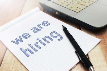 We Are Hiring, Motivational Business Recruitment Words Quotes Concept words letter, written on paper, work desk top view typography.の写真素材