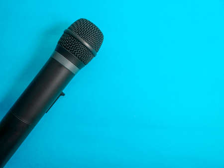 Microphone with copy space. Mic on blue background. Singing karaoke song concept