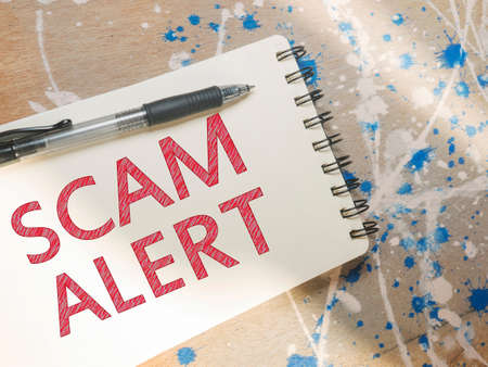 Scam Alert, Internet Fraudulent quotes, words typography top view lettering conceptの写真素材