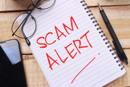Scam Alert, Internet Fraudulent quotes, words typography top view lettering conceptの写真素材