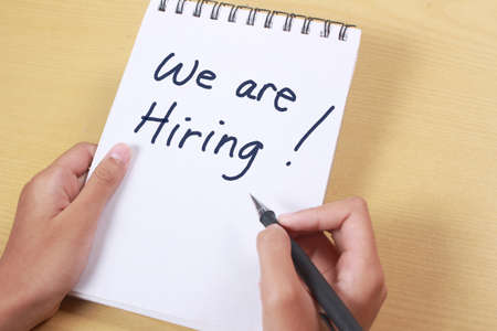 We Are Hiring, Motivational Business Recruitment Words Quotes Concept words letter, written on paper, work desk top view typography.の写真素材