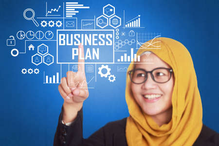 Business Concept. Businesswoman writing Business Plan words on virtual screen. Modern Text typography designの写真素材